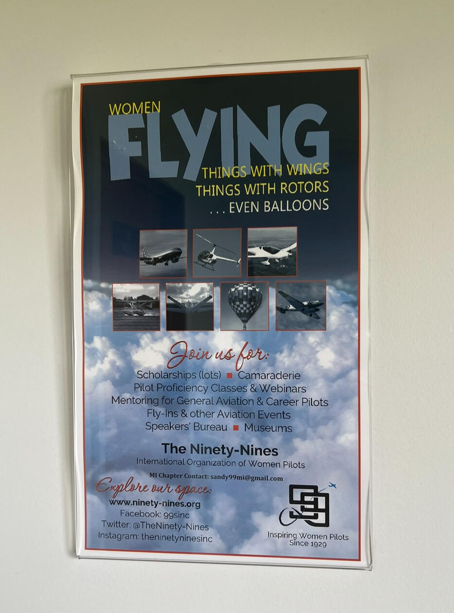 Ninety-Nines poster on the unisex bathroom wall at Three Rivers Municipal Airport, Michigan