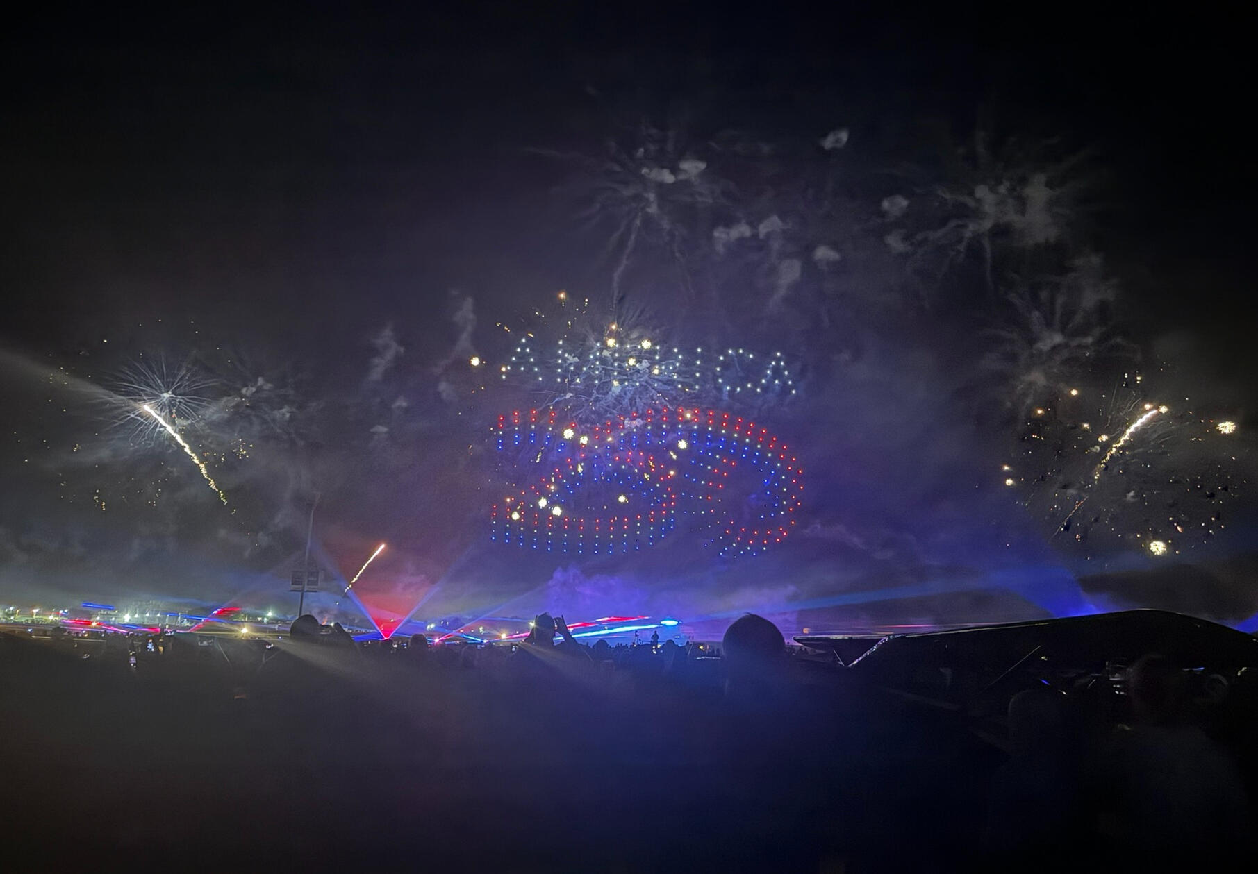 Drones making the American 250 logo in the sky, surrounded by fireworks