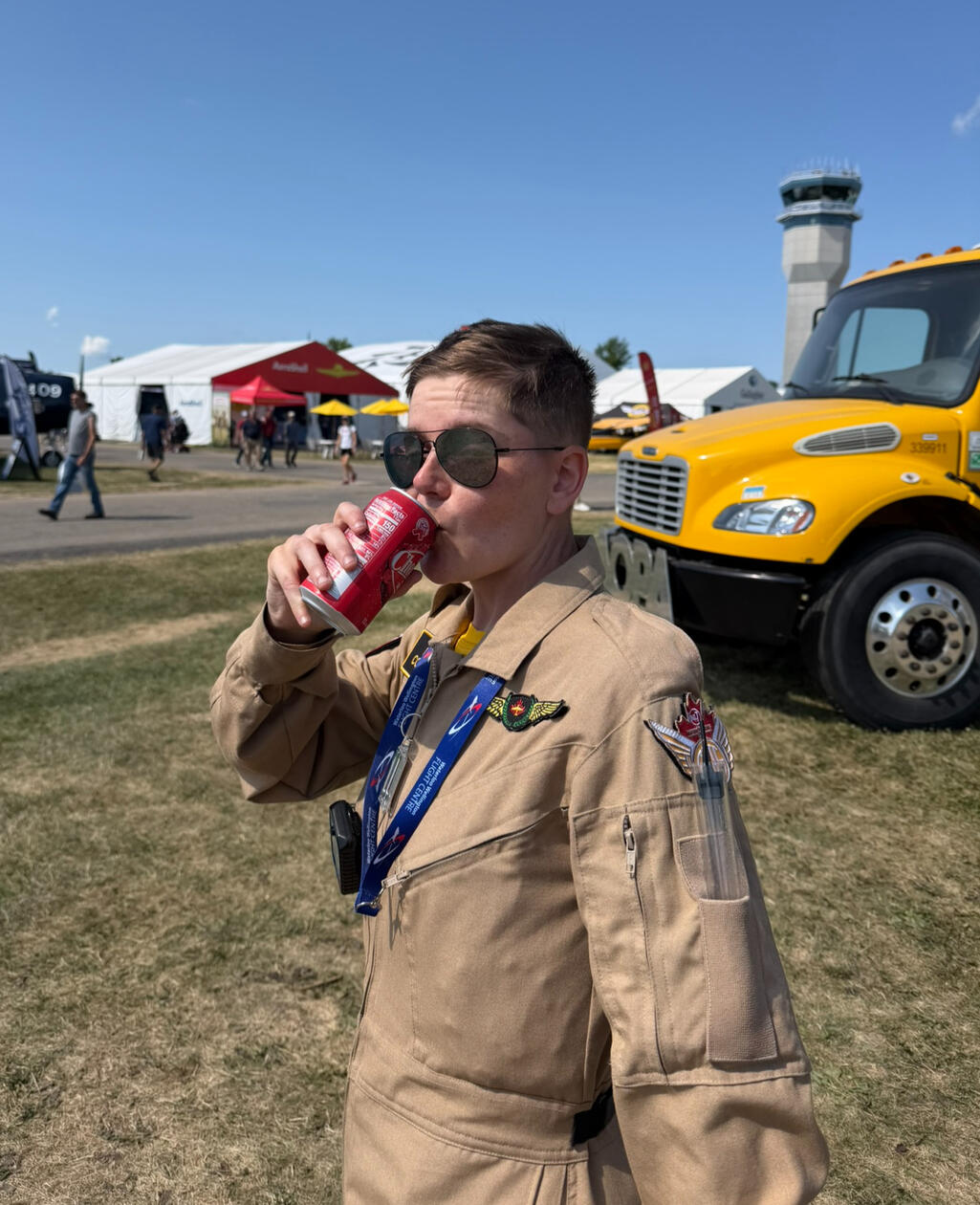 Lisa sipping on a cold can of Cheerwine after departure was delayed by an early B-52 arrival