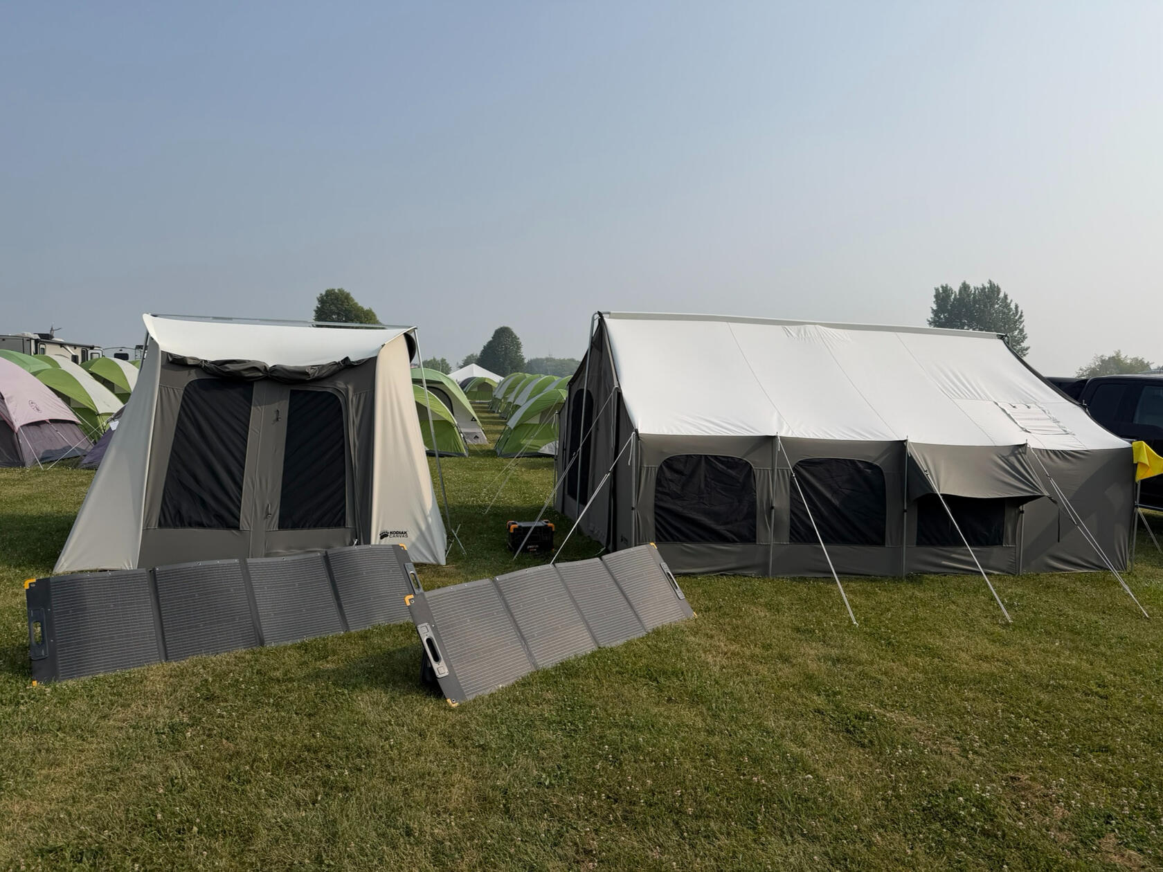Camp! Complete with massive solar panels. Chipmunk pilots on the left, camp quartermaster and support aircraft pilot on the right. The rest were in nearby trailers.